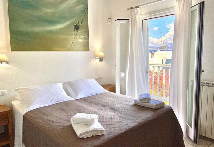 Elena Hotel, Mykonos. Budget gay honeymoon hotel room. Double bed, balcony with view. Best hotel in Mykonos Town Chora gayborhood.