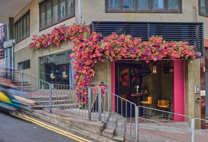 Fa Gai Hong Kong gay bar entrance. Pink flowers adorn the facade. Best gay bar with drag shows and live DJ in Hong Kong. Gay travel.