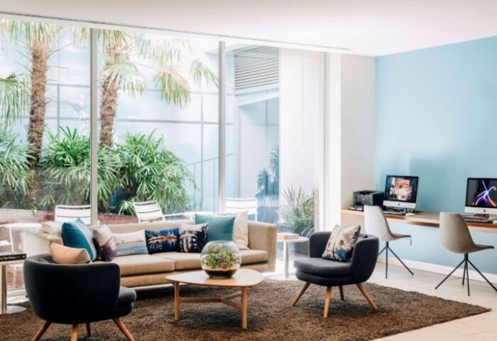 Saint Kilda Beach Hotel co-working space. Modern gay-friendly Melbourne hotel with lounge area, computers, and outdoor views.