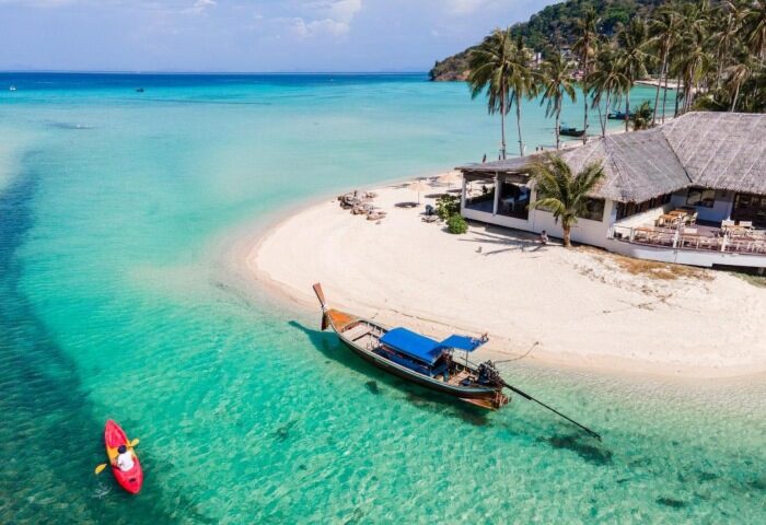 SAii Phi Phi Island Village: Beachfront hotel with full board meals. Kayaker, boat, & white sand beach in clear turquoise water. Gay travel.