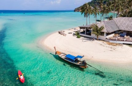 SAii Phi Phi Island Village: Beachfront hotel with full board meals. Kayaker, boat, & white sand beach in clear turquoise water. Gay travel.