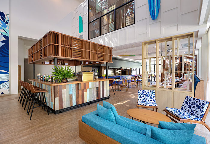 Outrigger Surin Beach Resort in Thailand. Interior of the beachfront hotel in Phuket, bar and seating area. Best gay hotel for gay men.