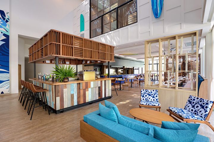 Outrigger Surin Beach Resort in Thailand. Interior of the beachfront hotel in Phuket, bar and seating area. Best gay hotel for gay men.
