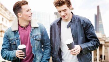 Gay couple at Andaz London Liverpool Street, a Shoreditch hotel. Two men with coffee in London. Best LGBT hotels near Liverpool Street.