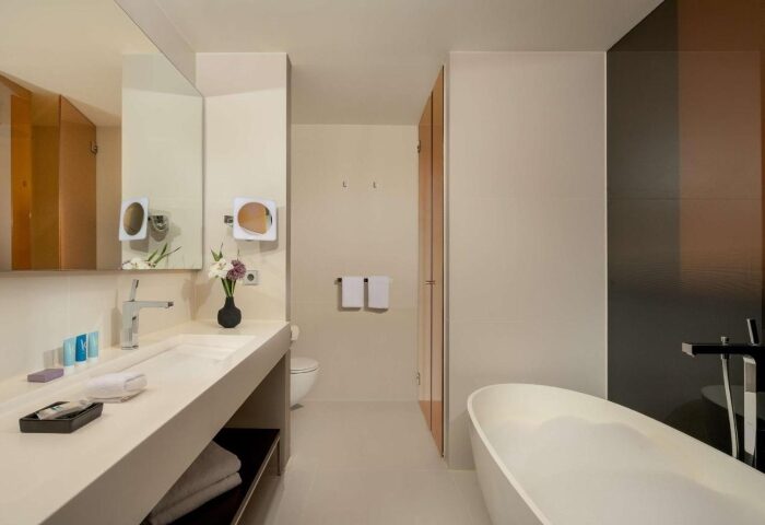 art'otel Amsterdam bathroom. Modern design with sink, mirror, tub, and toilet. Hotel near gay bars in Amsterdam for the best gay crowd.