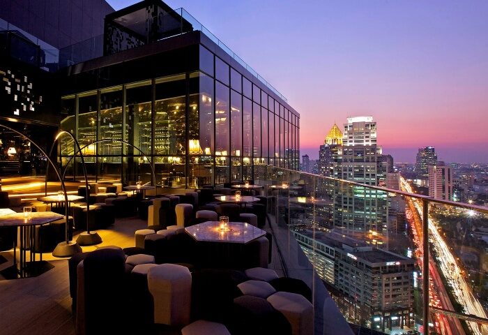 SO/ Bangkok Hotel's rooftop bar at dusk. A gay-friendly cocktail bar in Bangkok, Thailand, with city views. Perfect for a night out.