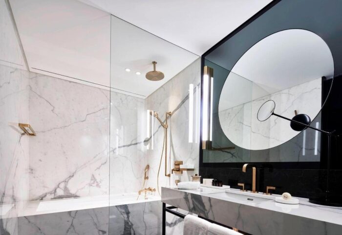 Academias Hotel, Autograph Collection bathroom. Gay honeymoon Athens luxury hotel with marble, gold fixtures, and modern design elements.