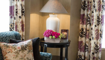 Les Tournelles hotel interior, best gay honeymoon hotel in Paris' gayborhood Marais. Lamp, flowers, curtains, pillows, table.