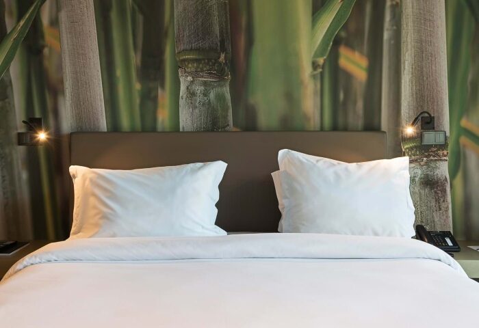 Saccharum Madeira bedroom with bamboo wallpaper. Best gay honeymoon spa resort in Portugal. Modern design, luxury travel, gay-friendly hotel.