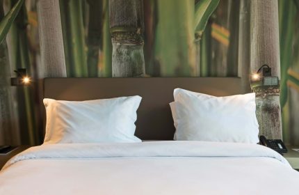 Saccharum Madeira bedroom with bamboo wallpaper. Best gay honeymoon spa resort in Portugal. Modern design, luxury travel, gay-friendly hotel.