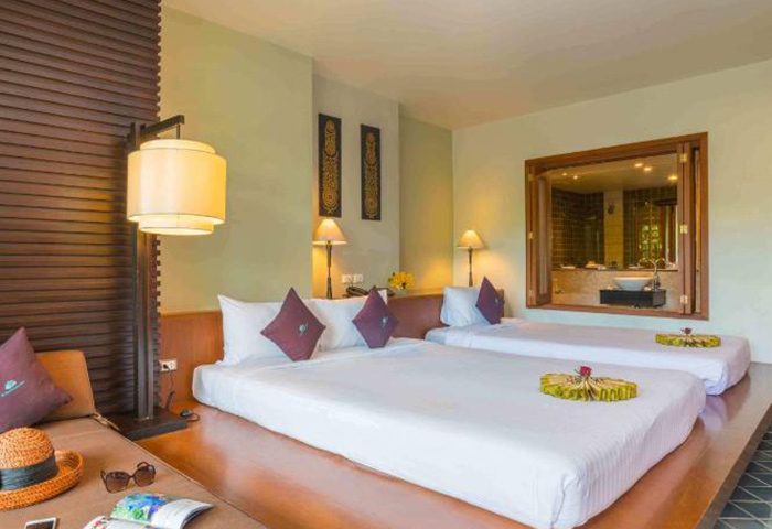 The Royal Paradise Hotel & Spa, Phuket: Best gay hotel for three people. Room with beds, bathroom view, hat, & sunglasses on a lounger.
