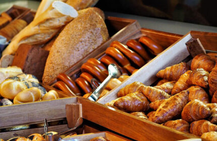 Hotel Kings Court's best breakfast: A wooden display of fresh bread, rolls, and croissants. A great start for gay travelers in Prague's Old Town.