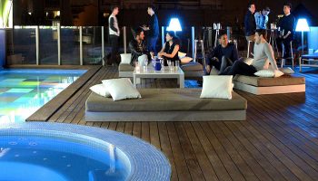 Axel Hotel Barcelona rooftop pool and bar at night. Gay adults only hotel, perfect for gay men to meet other gay men in Barcelona.