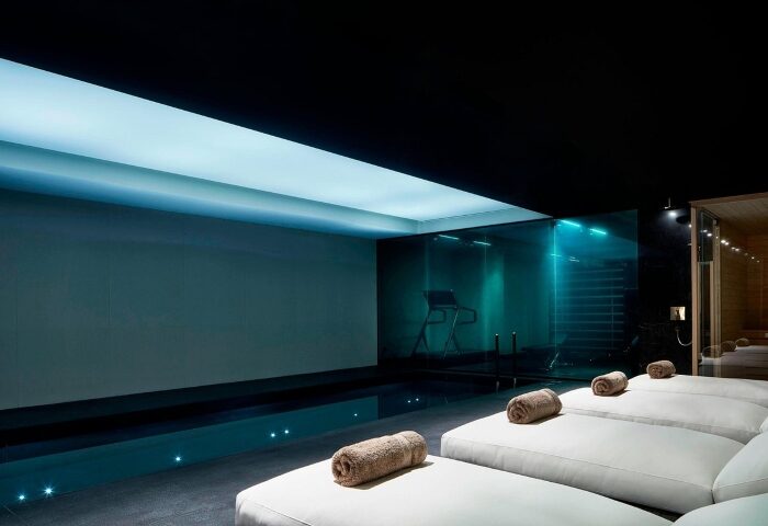 Academias Hotel swimming pool, a best gay hotel in Athens near gay bars. Loungers with rolled towels line the pool's edge. Modern, sleek design.