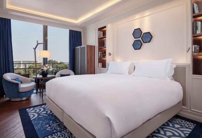Sofitel Barcelona Skipper room. Gay hotel near Mar Bella beach. Elegant interior, king bed, blue accents, city view. Best hotels for gay travelers.