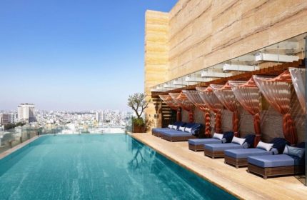 Hotel Des Arts Saigon MGallery Collection rooftop pool. Best gay hotels in Ho Chi Minh City. City view, lounge chairs.