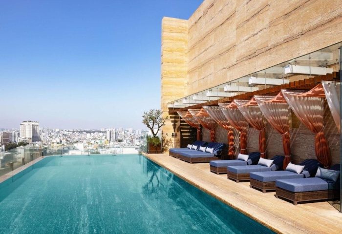Hotel Des Arts Saigon MGallery Collection rooftop pool. Best gay hotels in Ho Chi Minh City. City view, lounge chairs.