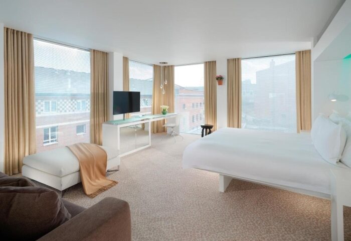 St Martins Lane Hotel London bedroom. Modern design, large windows, white linens. Near Buckingham Palace, ideal for gay travelers.