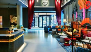 Andaz London Liverpool Street lobby. Best gay hotels London Shoreditch for gay couples. Revolving doors, plush seating, and modern design.