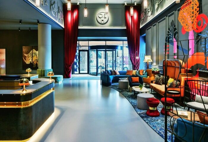 Andaz London Liverpool Street lobby. Best gay hotels London Shoreditch for gay couples. Revolving doors, plush seating, and modern design.