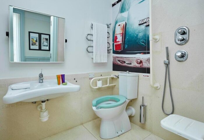 Bathroom at Hotel Indigo Rome - St. George, one of the best gay-friendly hotels near gay bars in Rome, featuring accessible design.