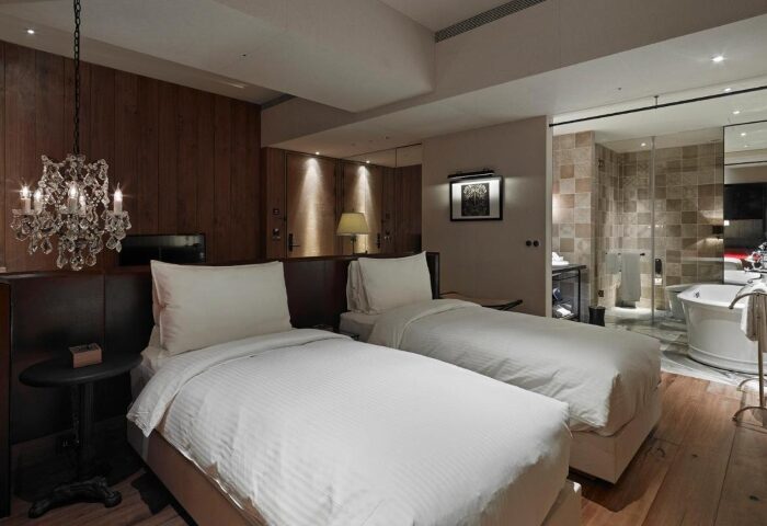 Hotel Proverbs Taipei room. Best gay hotels Taipei with near gay nightlife. Two beds, chandelier, and bathroom.