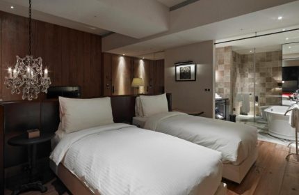 Hotel Proverbs Taipei room. Best gay hotels Taipei with near gay nightlife. Two beds, chandelier, and bathroom.