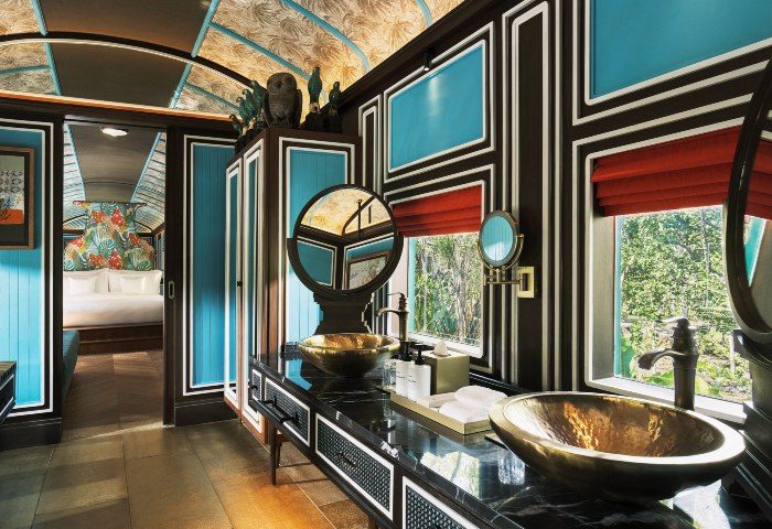 InterContinental Khao Yai Resort bathroom. Gay jungle hotels near Bangkok. Luxury train suite with gold sinks and jungle view.