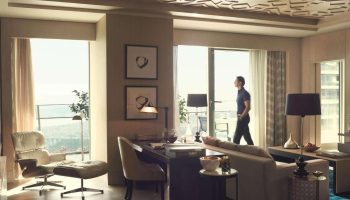 Raffles Istanbul Hotel luxury suite. A man enjoys the view on the River. Best gay-friendly hotel in Istanbul for gay men's travel.
