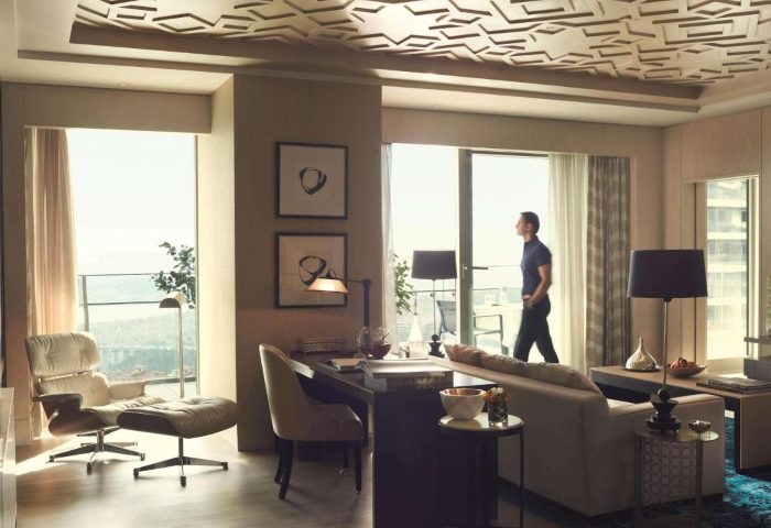 Raffles Istanbul Hotel luxury suite. A man enjoys the view on the River. Best gay-friendly hotel in Istanbul for gay men's travel.