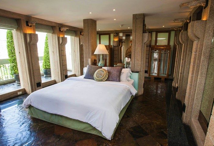 Babylon Bangkok Hotel room. Interior of the best gay men's hotel in Bangkok with great reviews, featuring a luxurious bed and balcony view.