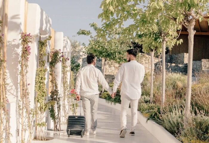 Gay couple arriving at Akkadian Gay Only Hotel Mykonos for their honeymoon. Best gay honeymoon hotel in Mykonos, Greece. Gay travel.