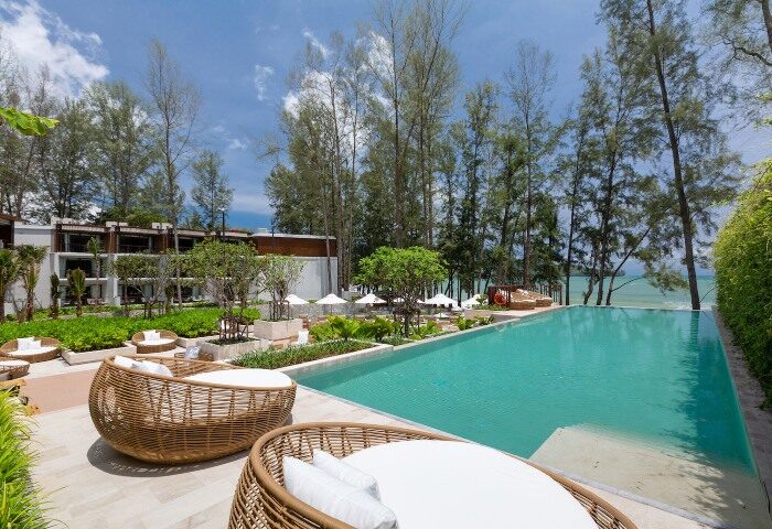 InterContinental Phuket Resort pool villa. Beachfront hotel view for gay travelers. Best gay hotels in Phuket. Infinity pool, loungers, palm trees.