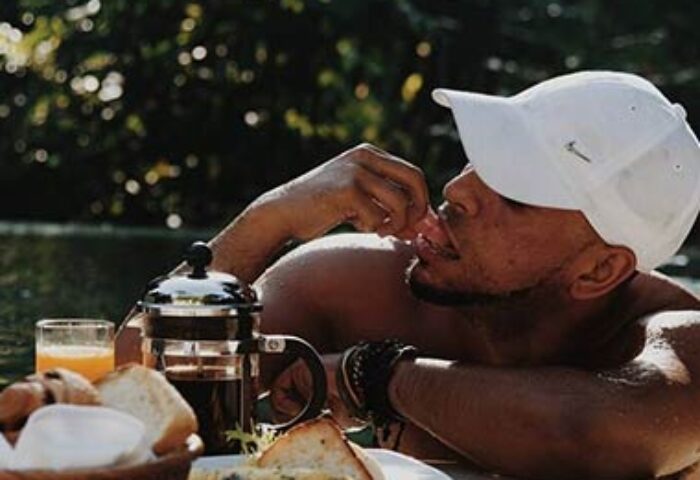 Gay man enjoying breakfast at The Haven Bali Seminyak. Best gay villa resort in Ubud, Bali. Relaxing vacation at a tropical travel destination.