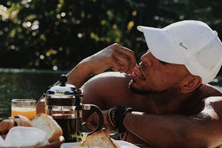 Gay man enjoying breakfast at The Haven Bali Seminyak. Best gay villa resort in Ubud, Bali. Relaxing vacation at a tropical travel destination.