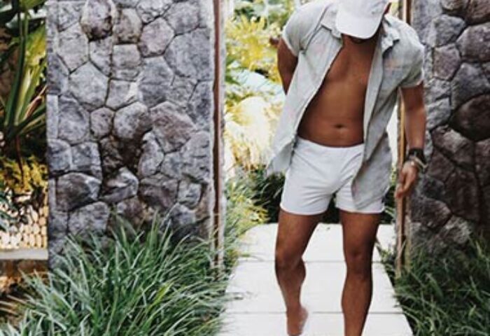 Gay man walking at The Haven Bali Seminyak. Best gay villas in Ubud, Bali. Tropical vacation lifestyle. Stylish resort wear.