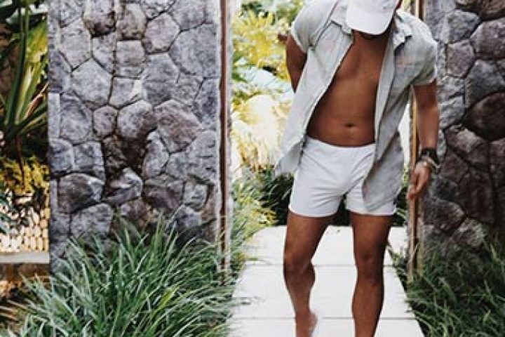 Gay man walking at The Haven Bali Seminyak. Best gay villas in Ubud, Bali. Tropical vacation lifestyle. Stylish resort wear.