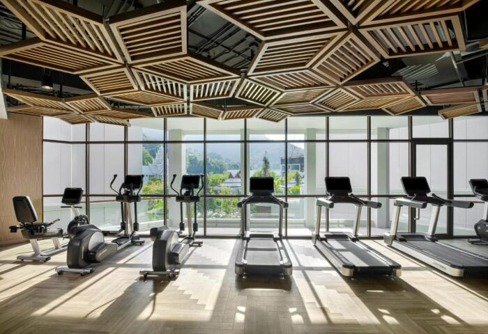 InterContinental Phuket Resort's gym. Treadmills, ellipticals, and stationary bikes face a scenic view. Best gay wellness hotels in Phuket.