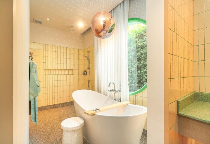 The Standard Hua Hin: Honeymoon beach resort bathroom for gay couples. Features a disco ball, bathtub, and unique design elements.