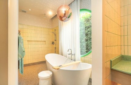 The Standard Hua Hin: Honeymoon beach resort bathroom for gay couples. Features a disco ball, bathtub, and unique design elements.