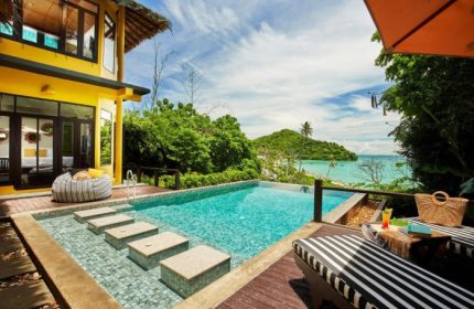 SAii Phi Phi Island Village: Beachfront pool at gay-friendly honeymoon hotel. Tropical view, lounge chairs, and turquoise water. Perfect for couples.