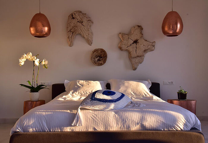 Hermes Mykonos Hotel bedroom. Best honeymoon hotel in Mykonos Town, Greece. Inspiration for gay travelers. Modern decor and relaxing atmosphere.