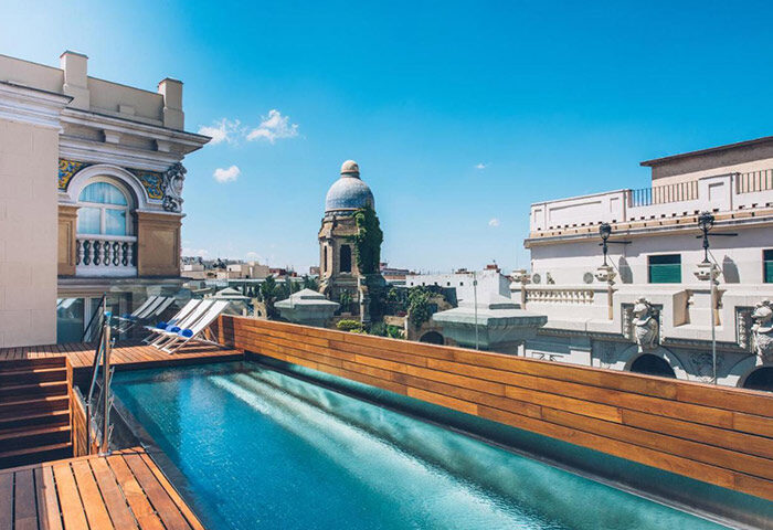 Iberostar Las Letras Gran Via rooftop pool, Madrid. Honeymoon hotel in gayborhood. View of city from luxury hotel. Best travel destination.