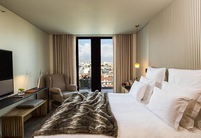 Memmo Principe Real Design Hotel room in Lisbon. Best honeymoon hotels inspiration. City center view from balcony. Gay travel advice.
