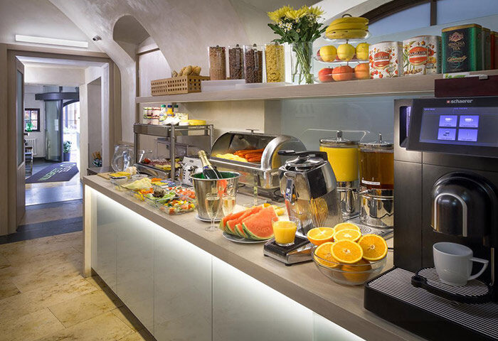 Hotel Clementin Old Town's best breakfast in Prague. A buffet with cereals, fruit, salad, juice, champagne, and coffee in the city center.
