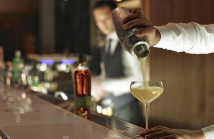 Hotel Proverbs Taipei cocktail bar. Bartender pouring drink into glass. Best hotel near Taipei gay nightlife for gay men travel.