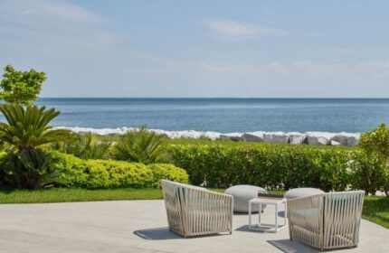 JW Marriott Hotel Istanbul Marmara Sea beachfront. Luxury gay hotel view with chairs, table, and ocean. Best place to relax and enjoy.