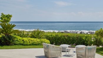 JW Marriott Hotel Istanbul Marmara Sea beachfront. Luxury gay hotel view with chairs, table, and ocean. Best place to relax and enjoy.