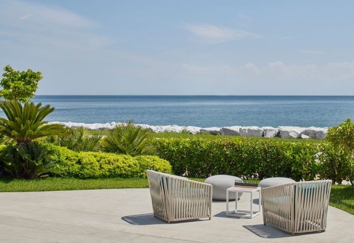 JW Marriott Hotel Istanbul Marmara Sea beachfront. Luxury gay hotel view with chairs, table, and ocean. Best place to relax and enjoy.