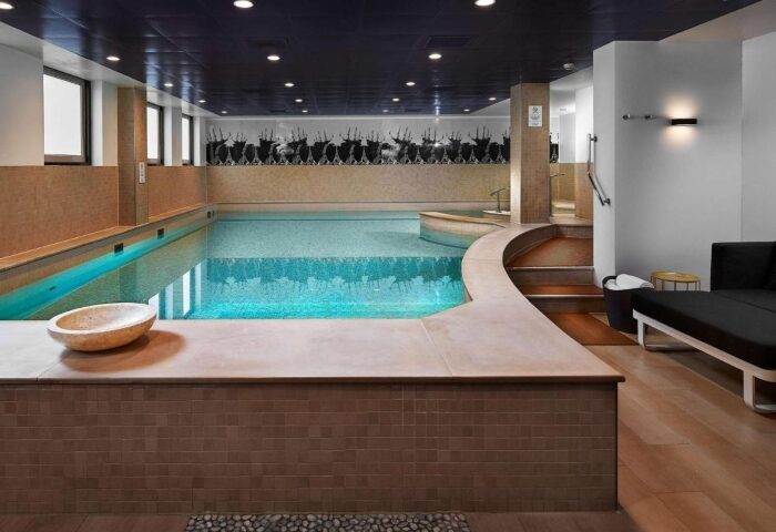 Indoor pool at Sofitel Legend The Grand Amsterdam, a luxury hotel. Swimming pool with lounge area. Best gay-friendly hotel in Amsterdam.